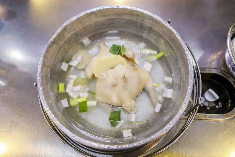 Dak-hanmari whole chicken hot pot simmering in a metal pot