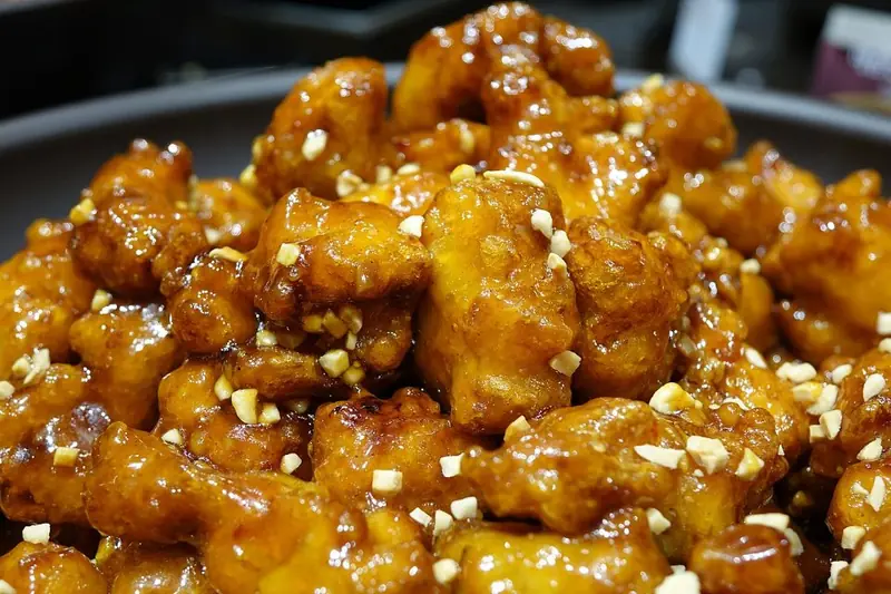 Dakgangjeong sweet and crispy glazed fried chicken pieces with sesame seeds