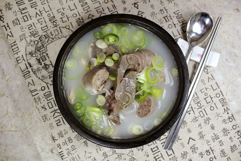 Bowl of haejangguk hangover soup with beef, vegetables and scallions
